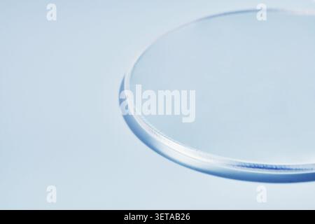 Minimalistic glass circle on light blue background with soft shadows Stock Photo