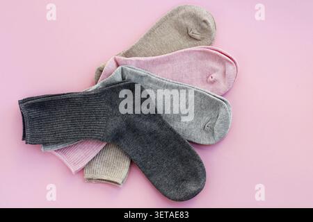 4 pairs of multi-colored cotton socks on a pink background. the concept of clothing made from natural materials Stock Photo