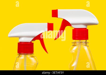 Detergent sprayers on a yellow background. Two sprayers. Stock Photo