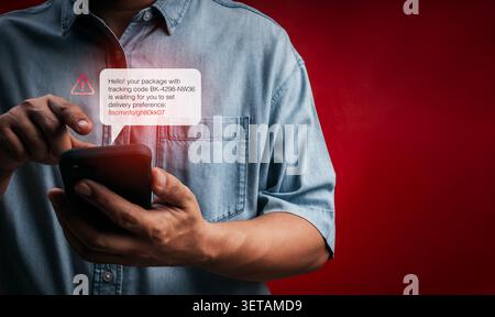 Person receiving fake delivery SMS with phishing tracking link on smartphone. Cyber scam, smishing attack, mobile fraud, fake package notification, id Stock Photo