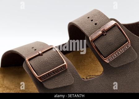 Close up of brown birkenstock sandals milano with bronze buckles and textured straps on white background. Stock Photo