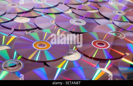Compact discs scattering, reflecting data storage and retro technology concepts Stock Photo