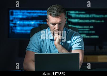 Developer works on secure software. Developer writes protection code system. Developer analyzes network vulnerabilities. Developer prevents cyber Stock Photo