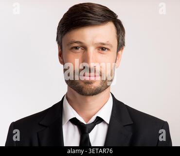 Professional Man in Formal Attire Posing Against a Neutral Background Stock Photo