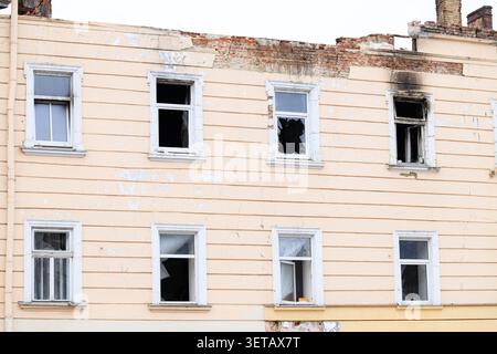 Damaged decay ruined building in Ukraine after russian invasion and missile attacks showing broken windows and war destruction Stock Photo