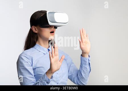 Woman Experiencing Virtual Reality Technology in a Modern Setting Stock Photo