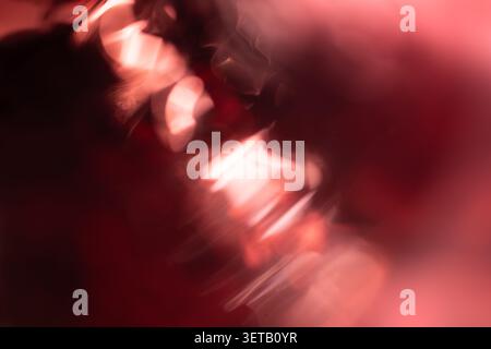 Abstract Motion Blur in Pink and Red Tones Creating Dreamy Aesthetic Stock Photo