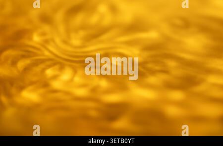 Golden Abstract Texture with Waves and Swirls in Blurred Close-up Light Stock Photo