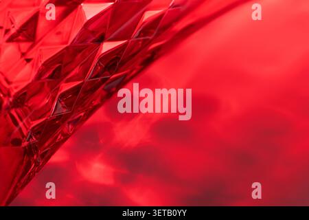 Abstract Red Glass Texture with Geometric Patterns and Intricate Light Reflections Stock Photo