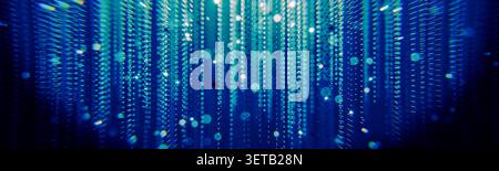 Spectacular abstract glowing blue green vertical data stream resembling matrix rain, featuring falling light particles over dark background, represent Stock Photo