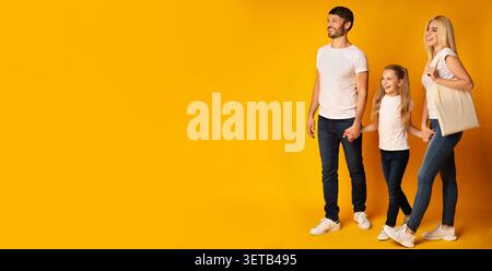 Family Enjoying Quality Time Together Against a Bright Yellow Backdrop in a Cheerful Atmosphere Stock Photo