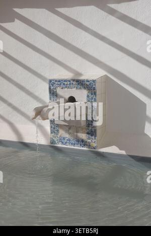Damaged Azulejo Tile Border on Whitewashed Wall with Diagonal Shadow Pattern, Lisbon Stock Photo