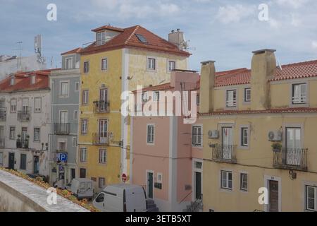 Colorful Alfama Residential Facades with Yellow and Pink Buildings, Lisbon, Portugal Stock Photo