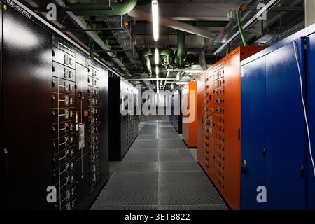 Lugano, Switzerland - 18 March 2026: View of the Swiss National Supercomputing Centre featuring rows of colorful server cabinets and industrial infras Stock Photo