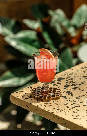 Fresh grapefruit cocktail with ice on table Stock Photo