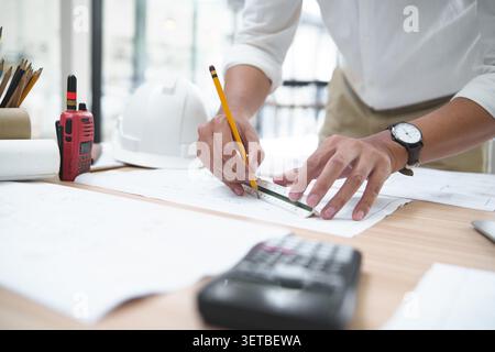 Architect or Engineer Working on Blueprints with Tools and Equip Stock Photo