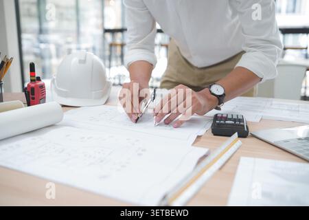 Architect or Engineer Working on Blueprint with Drawing Tools in Stock Photo