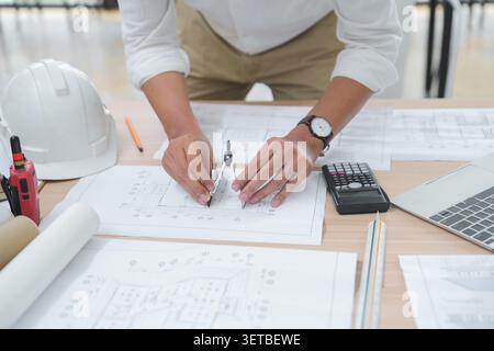 Architect or Engineer Working on Blueprint with Drawing Tools in Stock Photo