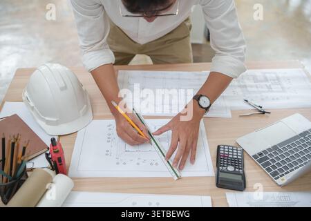 Architect or Engineer Working on Construction Plans with Tools a Stock Photo