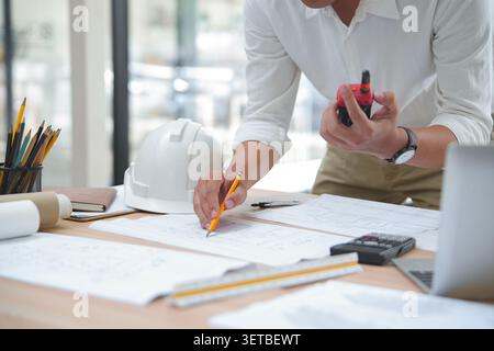 Engineer Reviewing Construction Plans with Tools and Documentati Stock Photo