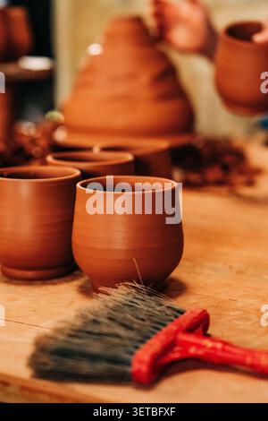 Handmade clay cups waiting in pottery workshop Stock Photo