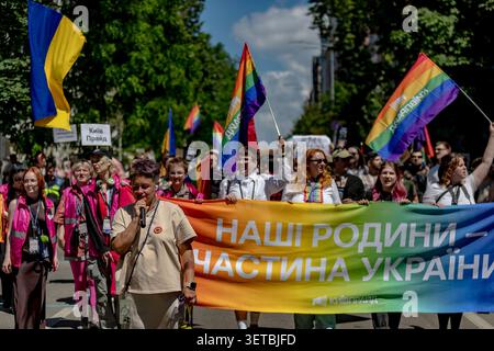 Kyiv, Ukraine. 21st June, 2026. Participants carry a banner reading “Наші родини - частина України” (“Our families are part of Ukraine”) during Kyiv Pride in Kyiv, Ukraine, on Sunday, June 21, 2026. The annual march brought together LGBTQ  activists, supporters and allies amid continuing wartime conditions. (Photo: Vudi Xhymshiti, for The Pictures UK) Credit: VX Pictures/Ģ����ý Live News Stock Photo