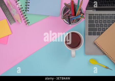 Creative workspace concept with laptop notebooks and coffee on colorful background Stock Photo
