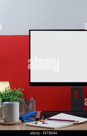 Workspace concept with blank computer screen and notebook on wooden desk Stock Photo