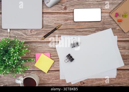 Flat lay workspace mockup with blank paper smartphone and coffee on wooden desk Stock Photo