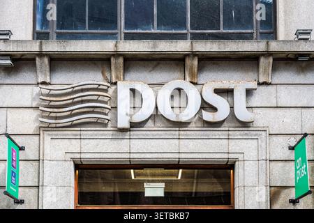 An Post post office building exterior signage on granite stone facade in Dublin city centre Ireland Stock Photo