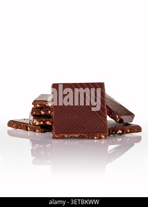 Stacked artisan dark chocolate with nuts and fruit Stock Photo
