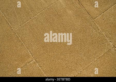 High angle close up shot of a yellow textured rubber flooring with geometric seams on a modern children playground Stock Photo