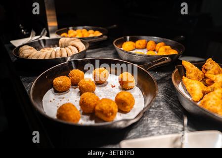 Fried snacks buffet at luxury Maldives resort under warm lighting Stock Photo