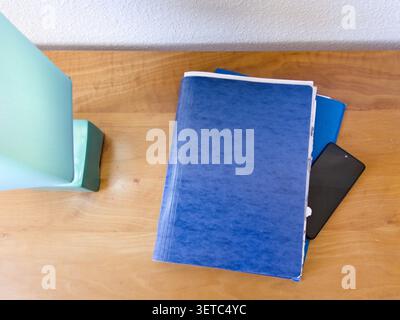 Mobile phone on top of folders that contain documents Stock Photo