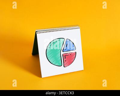 Notebook displaying a colorful hand drawn pie chart diagram, representing market share Stock Photo