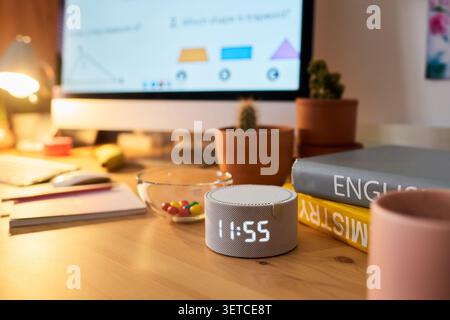 Smart Speaker on Teen Study Desk Supporting Home Learning Routine Stock Photo