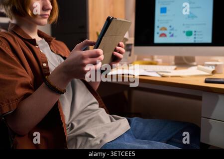 Teenager Using Tablet at Home for Online Learning Stock Photo