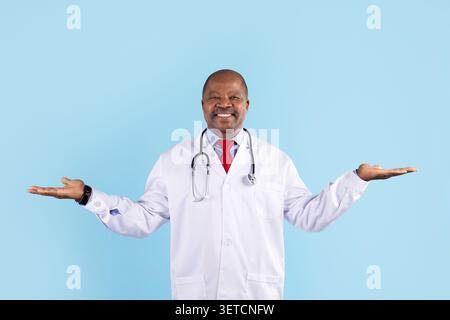 Mature African American doctor in white coat raising both open palms Stock Photo