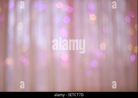 soft, blurred background featuring bokeh lights in shades of purple and yellow. dreamy atmosphere created by colors makes it perfect for artistic, cel Stock Photo