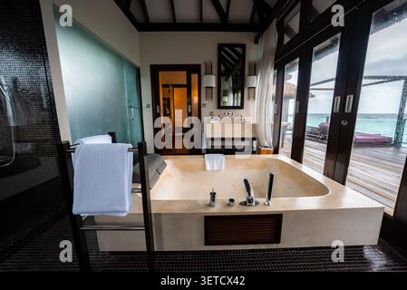 Maldives overwater villa bathroom with sunken tub and sea view Stock Photo
