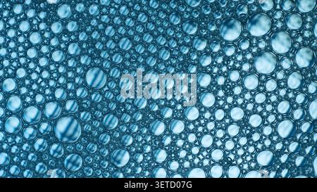 Blue foam bubbles creating an abstract liquid pattern Stock Photo