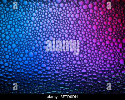 Colorful bubbles creating abstract texture on liquid surface Stock Photo