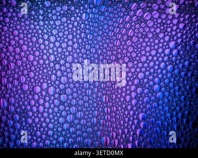 Colorful bubbles creating abstract texture on liquid surface Stock Photo