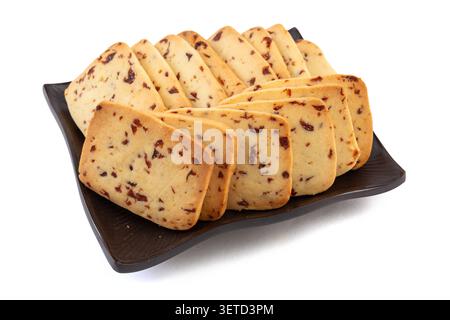 A heap of rectangular cranberry butter cookies with dried fruit bits scattered on a white background. Stock Photo