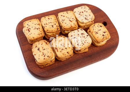 A heap of rectangular cranberry butter cookies with dried fruit bits scattered on a white background. Stock Photo