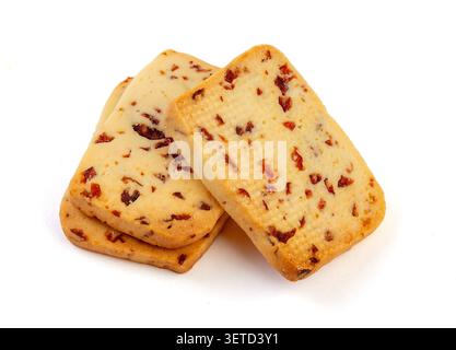 A heap of rectangular cranberry butter cookies with dried fruit bits scattered on a white background. Stock Photo