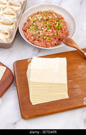 Ingredients for Making Chinese Wontons with Dumpling Wrappers and Minced Meat Stuffing Stock Photo
