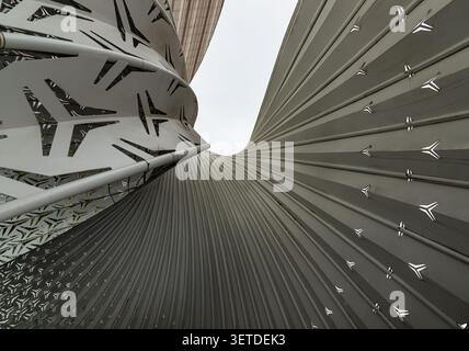 Chongqing, China - 8 Jun 2026 - a dramatic low angle, this architectural detail highlights a futuristic dialogue between form, light, and texture. On Stock Photo