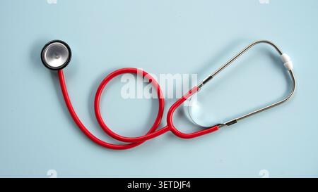 A medical stethoscope with an red tube neatly arranged on a clean white background, ideal for healthcare, medicine, or clinical concepts. Stock Photo