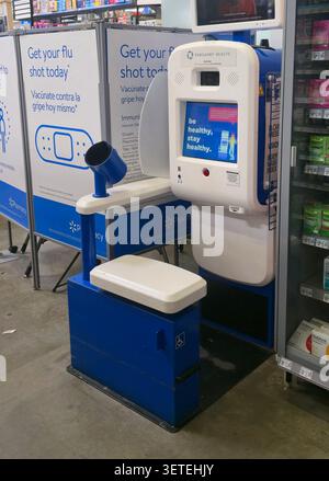Self-service blood pressure monitoring kiosk inside a Walmart pharmacy in the United States. The automated health screening station Stock Photo